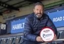 The Kilmarnock manager celebrates with his award