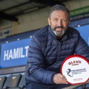 The Kilmarnock manager celebrates with his award